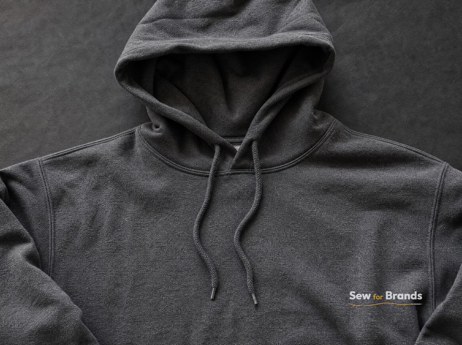 Chest area of a charcoal hoodie showing brushed fleece texture
