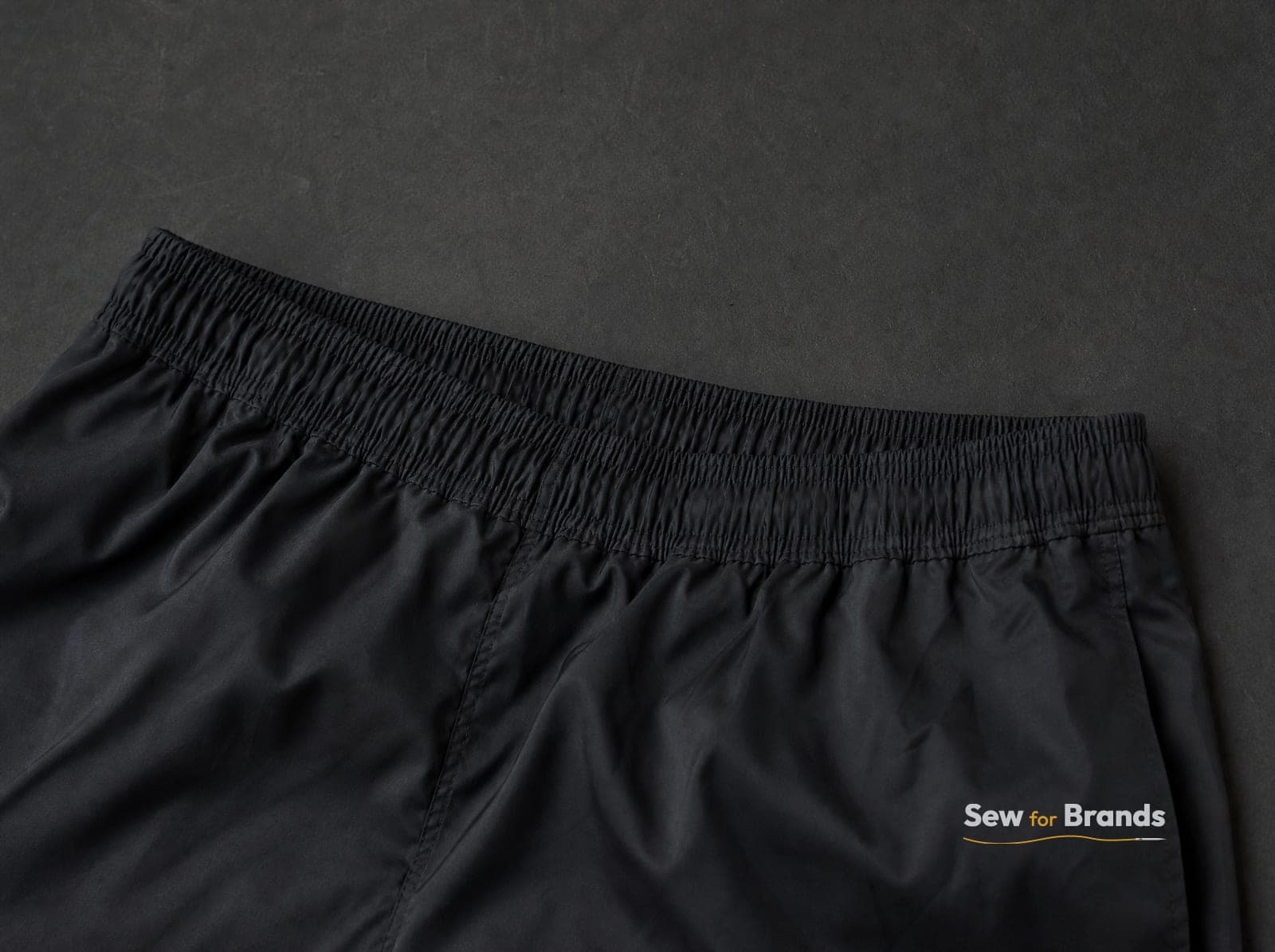 Elastic waistband of black athletic shorts, close-up