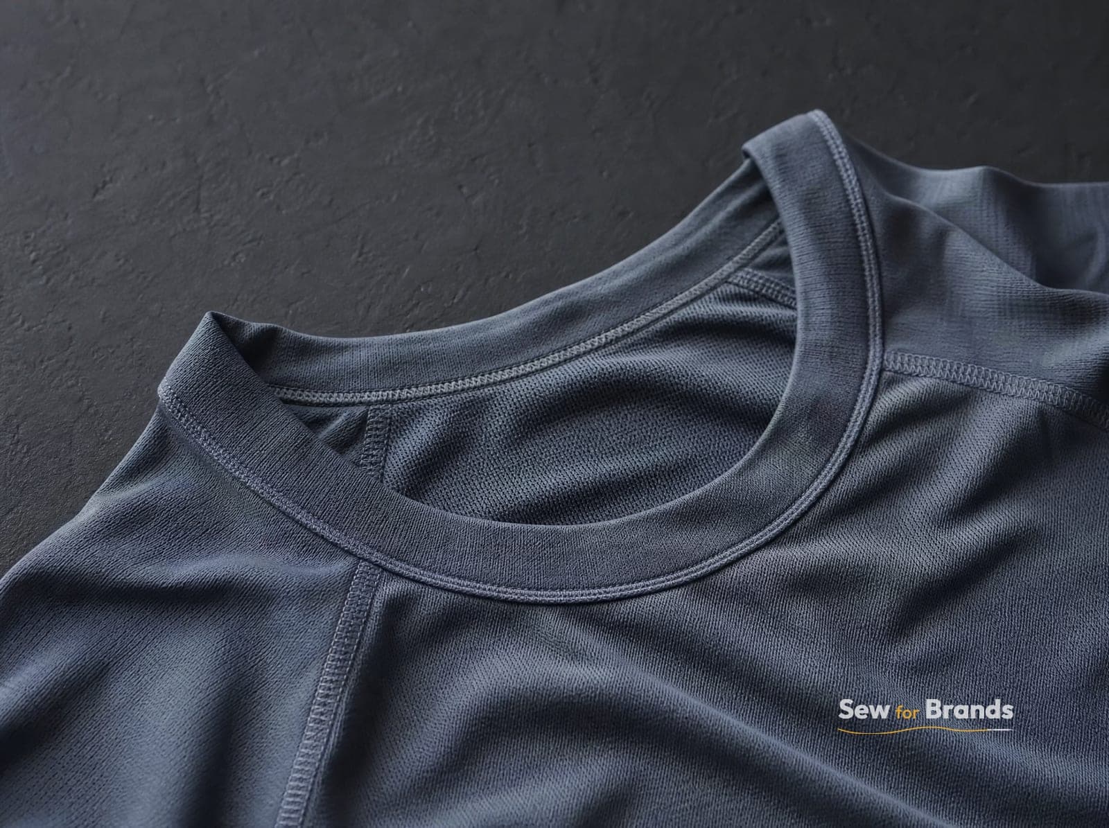 Neckline and flatlock seams of a performance t-shirt, close-up