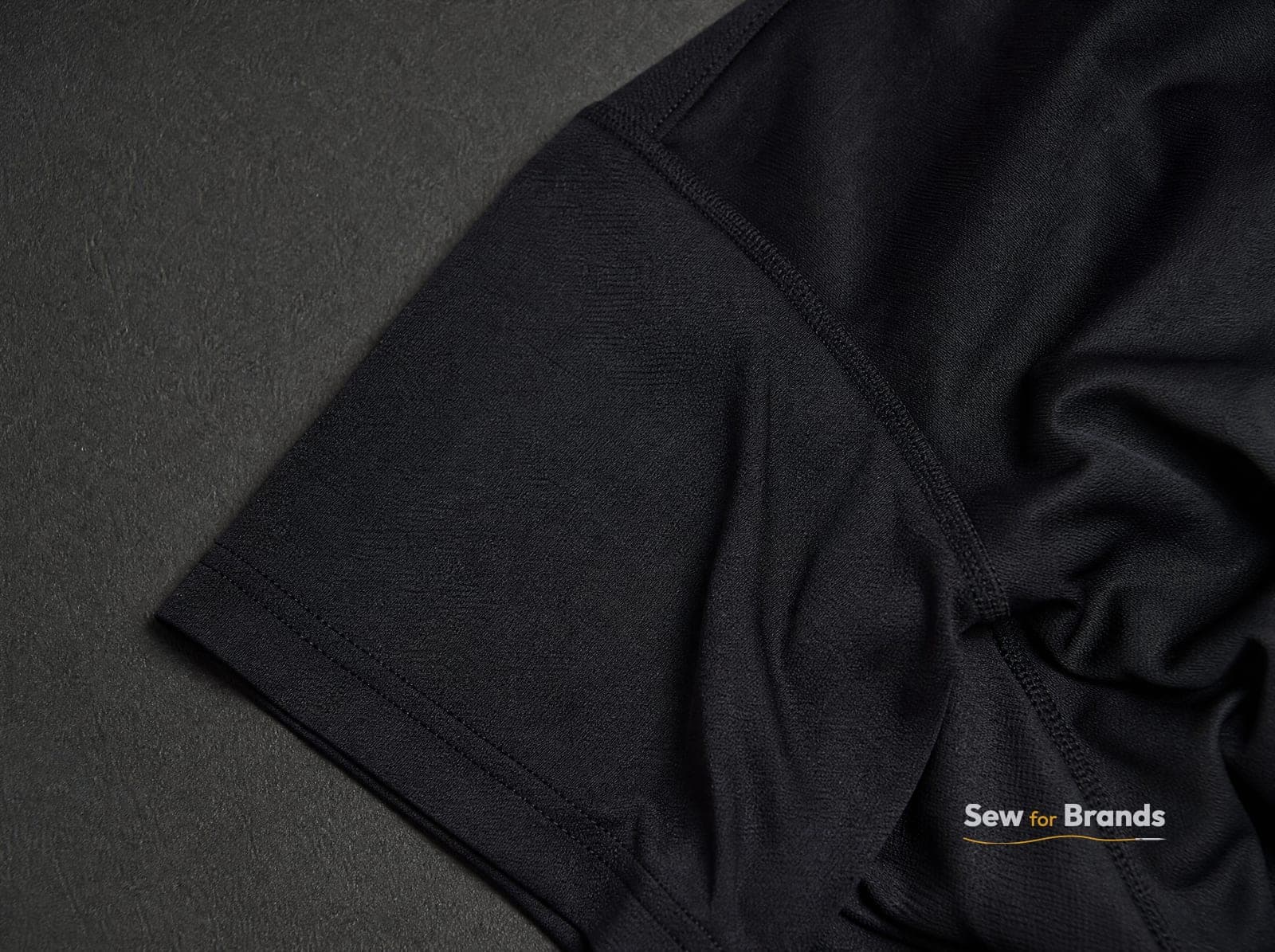 Close-up fabric of lightweight moisture-wicking black polyester knit